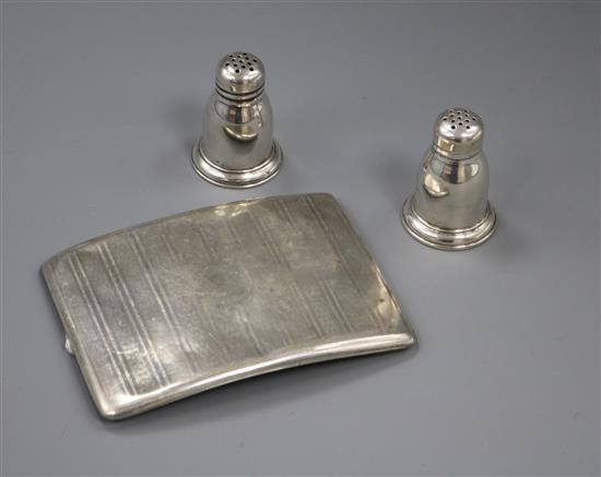 A silver cigarette case and a pair of sterling silver condiments.